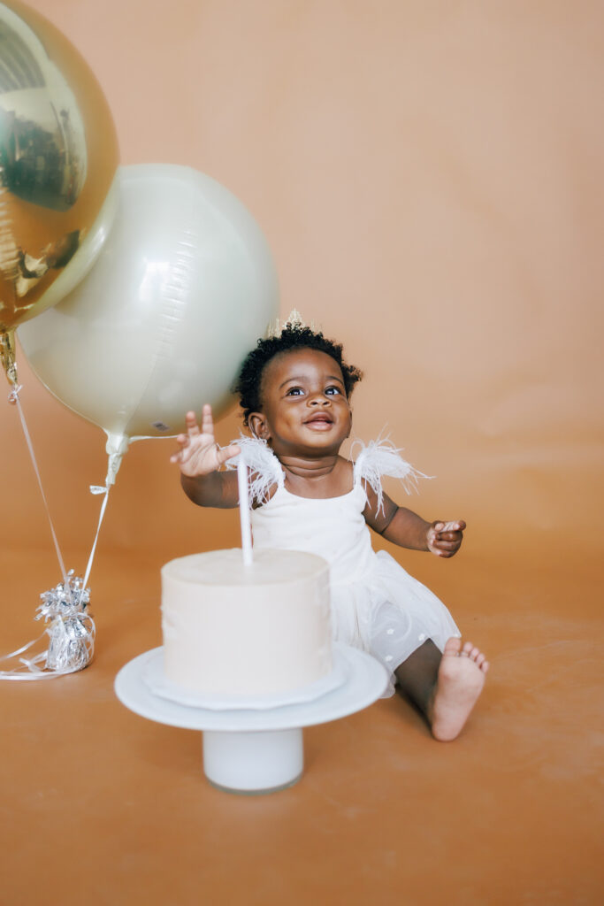 baby girl one year photo shoot with smash cake