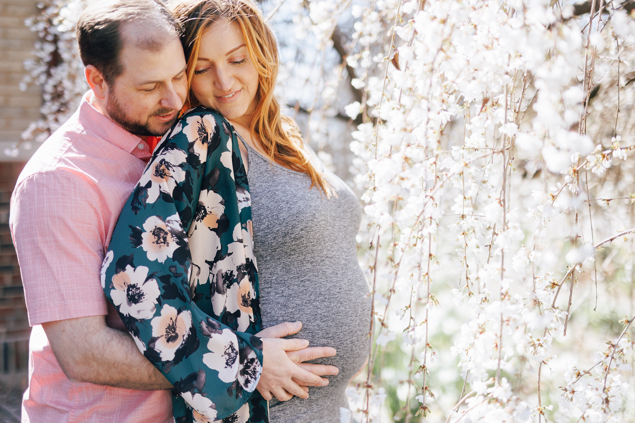 maternity photo shoot in the spring infront of cherry blossom tree.