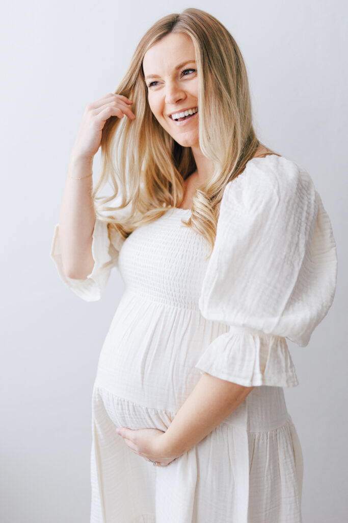 maternity shoot with white maternity princess sleeve dress.