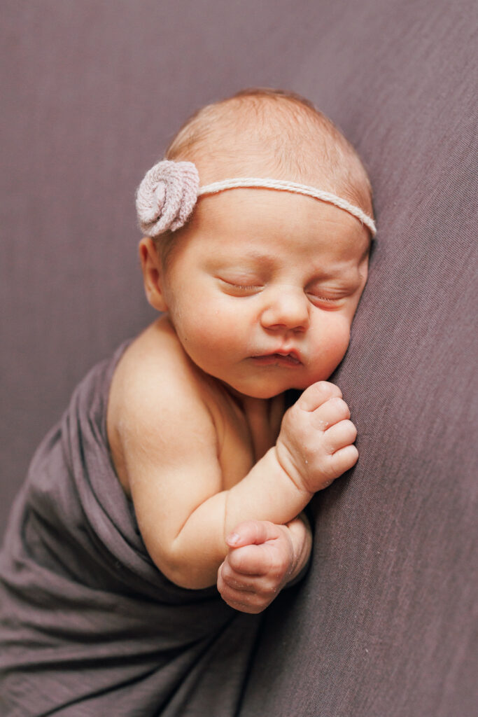 newborn portrait of baby girl in purple in worthington ohio newborn studio